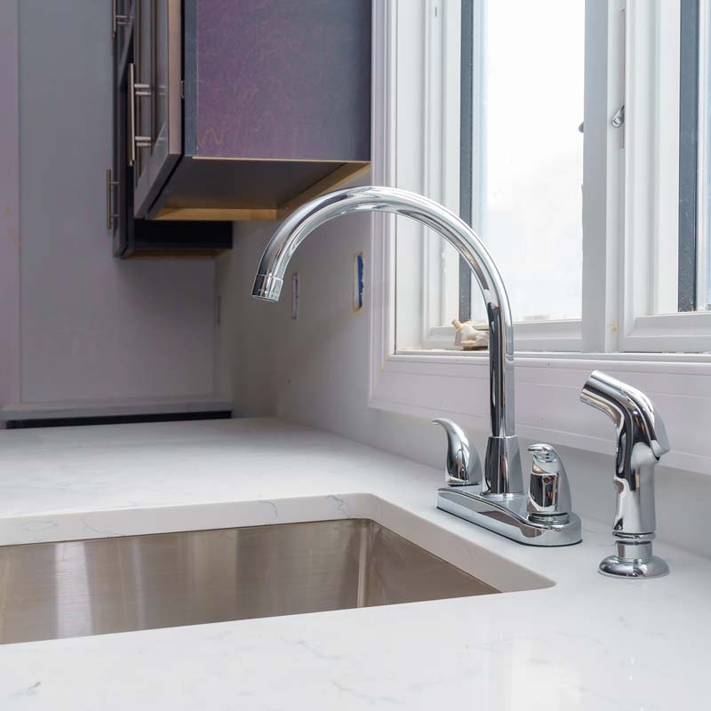 faucet kitchen sink with brick wall col